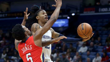 Memphis Grizzlies guard Ja Morant (12) drives past New Orleans Pelicans forward Herbert Jones (5) Credit: Chuck Cook-USA TODAY Sports