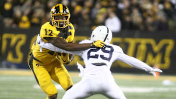 IOWA CITY, IOWA- OCTOBER 12: Wide receiver Brandon Smith #12 of the Iowa Hawkeyes rushes up field during the first half against cornerback John Reid #29 of the Penn State Nittany Lions on October 12, 2019 at Kinnick Stadium in Iowa City, Iowa. (Photo by Matthew Holst/Getty Images)