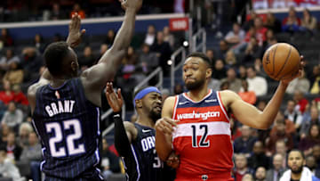 WASHINGTON, DC - MARCH 13: Jabari Parker #12 of the Washington Wizards passes the ball around Jerian Grant #22 of the Orlando Magic in the second half at Capital One Arena on March 13, 2019 in Washington, DC. NOTE TO USER: User expressly acknowledges and agrees that, by downloading and or using this photograph, User is consenting to the terms and conditions of the Getty Images License Agreement. (Photo by Rob Carr/Getty Images)