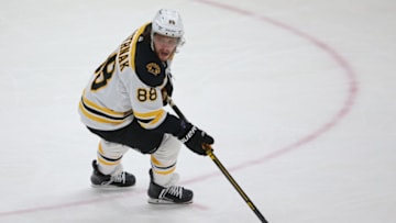 Feb 13, 2021; Uniondale, New York, USA; Boston Bruins right wing David Pastrnak (88) plays the puck against the New York Islanders during the third period at Nassau Veterans Memorial Coliseum. Mandatory Credit: Brad Penner-USA TODAY Sports