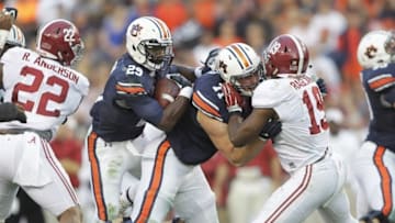 Nov 28, 2015; Auburn, AL, USA; Auburn Tigers running back Jovon Robinson follows the block of lineman Braden Smith (71) as he blocks Alabama Crimson Tide linebacker Adonis Thomas (17) during the second quarter at Jordan Hare Stadium. Mandatory Credit: John Reed-USA TODAY Sports