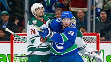 VANCOUVER, BC - OCTOBER 29: Matt Dumba #24 of the Minnesota Wild checks Tim Schaller #59 of the Vancouver Canucks during their NHL game at Rogers Arena October 29, 2018 in Vancouver, British Columbia, Canada. (Photo by Jeff Vinnick/NHLI via Getty Images)