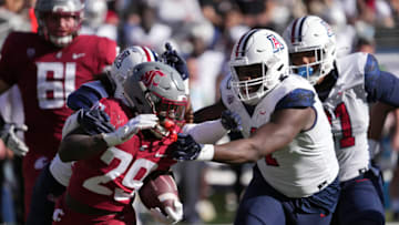 Nov 19, 2022; Tucson, Arizona, USA; Arizona Wildcats cornerback Christian Roland-Wallace (4) attempts to tackle Washington State Cougars running back Jaylen Jenkins (29) during the second half at Arizona Stadium. Mandatory Credit: Joe Camporeale-USA TODAY Sports
