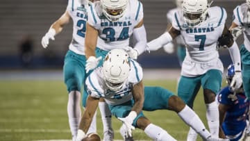 Linebacker Enock Makonzo the Coastal Carolina Chanticleers recovers a fumble during the game against Kansas football. (Photo by Brian Davidson/Getty Images)