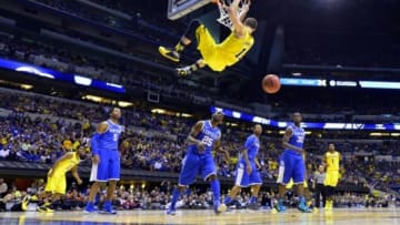 Mar 30, 2014; Indianapolis, IN, USA; Michigan Wolverines guard Nik Stauskas (11) dunks against the Kentucky Wildcats in the second half of the finals of the midwest regional of the 2014 NCAA Mens Basketball Championship tournament at Lucas Oil Stadium. Mandatory Credit: Bob Donnan-USA TODAY Sports