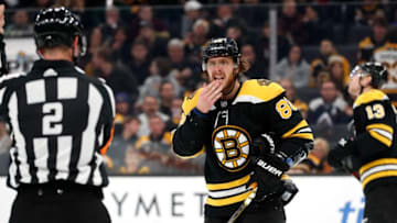 BOSTON, MA - DECEMBER 07: Boston Bruins right wing David Pastrnak (88) asks if he is bleeding to referee Jon McIssac (2) during a game between the Boston bruins and the Colorado Avalanche on December 7, 2019, at TD Garden in Boston, Massachusetts. (Photo by Fred Kfoury III/Icon Sportswire via Getty Images)