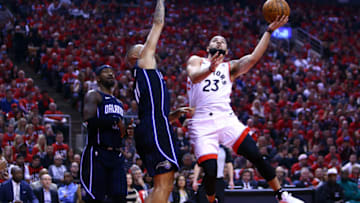 TORONTO, ON - APRIL 13: Fred VanVleet #23 of the Toronto Raptors shoots the ball as Evan Fournier #10 of the Orlando Magic defends in the first half during Game One of the first round of the 2019 NBA Playoff at Scotiabank Arena on April 13, 2019 in Toronto, Canada. NOTE TO USER: User expressly acknowledges and agrees that, by downloading and or using this photograph, User is consenting to the terms and conditions of the Getty Images License Agreement. (Photo by Vaughn Ridley/Getty Images)