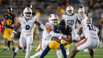 Auburn footballSep 9, 2023; Berkeley, California, USA; California Golden Bears wide receiver Taj Davis (9) is tackled by Auburn Tigers cornerback Kayin Lee (3) during the fourth quarter at California Memorial Stadium. Mandatory Credit: Neville E. Guard-USA TODAY Sports