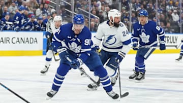 Apr 20, 2023; Toronto, Ontario, CAN; Toronto Maple Leafs center John Tavares (91) skates with the puck as Tampa Bay Lightning defenseman Zach Bogosian (24) tries to defend during the third period in game two of the first round of the 2023 Stanley Cup Playoffs at Scotiabank Arena. Mandatory Credit: Nick Turchiaro-USA TODAY Sports
