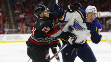Feb 28, 2016; Raleigh, NC, USA; Carolina Hurricanes defensemen John-Michael Liles (26) and St. Louis Blues forward Dmitrij Jaskin (23) watch the play during the third period at PNC Arena. The St. Louis Blues defeated the Carolina Hurricanes 5-2. Mandatory Credit: James Guillory-USA TODAY Sports