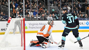 Feb 16, 2023; Seattle, Washington, USA; Seattle Kraken center Yanni Gourde (37) scores a goal past Philadelphia Flyers goaltender Carter Hart (79) during the first period at Climate Pledge Arena. Mandatory Credit: Steven Bisig-USA TODAY Sports
