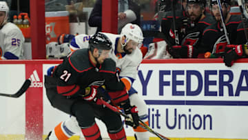 RALEIGH, NC - MAY 03: Nino Niederreiter #21 of the Carolina Hurricanes battles for a puck near the red line with Scott Mayfield #24 of the New York Islanders in Game Four of the Eastern Conference Second Round during the 2019 NHL Stanley Cup Playoffs on May 3, 2019 at PNC Arena in Raleigh, North Carolina. (Photo by Gregg Forwerck/NHLI via Getty Images)