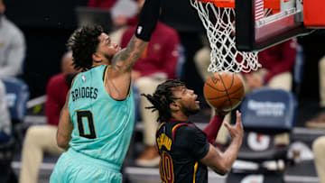 Apr 23, 2021; Charlotte, North Carolina, USA; Charlotte Hornets forward Miles Bridges (0) attempts a block on Cleveland Cavaliers guard Darius Garland (10) during the second quarter at the Spectrum Center. Mandatory Credit: Jim Dedmon-USA TODAY Sports