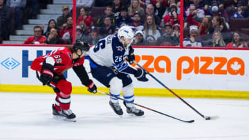 OTTAWA, ON - APRIL 02: Winnipeg Jets Right Wing Blake Wheeler (26) tries to get around Ottawa Senators Defenceman Erik Karlsson (65) during third period National Hockey League action between the Winnipeg Jets and Ottawa Senators on April 2, 2018, at Canadian Tire Centre in Ottawa, ON, Canada. (Photo by Richard A. Whittaker/Icon Sportswire via Getty Images)