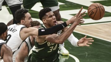 Jun 10, 2021; Milwaukee, Wisconsin, USA; Milwaukee Bucks forward Giannis Antetokounmpo (34) and Brooklyn Nets guard Landry Shamet (20) battle for a loose ball in the fourth quarter during game three in the second round of the 2021 NBA Playoffs at Fiserv Forum. Mandatory Credit: Benny Sieu-USA TODAY Sports