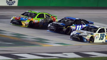 Jul 11, 2015; Sparta, KY, USA; Sprint Cup Series driver Kyle Busch (18) Sprint Cup Series driver Denny Hamlin (11) and Sprint Cup Series driver Carl Edwards (19) go three wide across the start line on a restart during the Quaker State 400 at Kentucky Speedway. Mandatory Credit: Christopher Hanewinckel-USA TODAY Sports