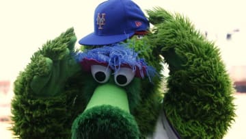 PHILADELPHIA, PA - OCTOBER 01: The Phillie Phanatic puts on the Mets cap of Jeurys Familia