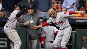 HOUSTON, TX - OCTOBER 18: Red Sox Rafael Devers gets the hero's welcome from manager Alex Cora and Mookie Betts following his sixth inning tree run home run that gave Boston a 4-0 lead. The Boston Red Sox visited the Houston Astros for Game Five of their ALCS baseball matchup at Minute Maid Park in Houston on Oct. 18, 2018. (Photo by Jim Davis/The Boston Globe via Getty Images)