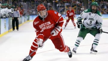 Apr 9, 2015; Boston, MA, USA; Boston University forward Jack Eichel (9) gets past North Dakota forward Drake Caggiula (9) during the third period of a semifinal game in the men