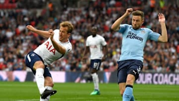 LONDON, ENGLAND - MAY 09: Harry Kane of Totenham Hotspur shoots while under pressure from Paul Dummett of Newcastle United during the Premier League match between Tottenham Hotspur and Newcastle United at Wembley Stadium on May 9, 2018 in London, England. (Photo by Stu Forster/Getty Images)