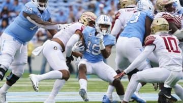 Oct 9, 2021; Chapel Hill, North Carolina, USA; North Carolina Tar Heels running back Ty Chandler (19) runs with the ball against the Florida State Seminoles at Kenan Memorial Stadium. Mandatory Credit: James Guillory-USA TODAY Sports