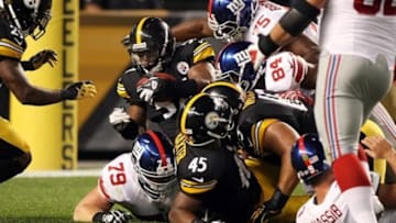 Aug 10, 2013; Pittsburgh, PA, USA; Pittsburgh Steelers linebacker Adrian Robinson (57) recovers a fumble in the end zone for a touchdown against the New York Giants during the second half at Heinz Field. The Giants won the game, 18-13. Mandatory Credit: Jason Bridge-USA TODAY Sports