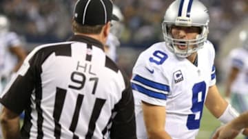 Dec 15, 2013; Arlington, TX, USA; Dallas Cowboys quarterback Tony Romo (9) yells at head linesman Jerry Bergman (91) after throwing an interception in the fourth quarter against the Green Bay Packers at AT&T Stadium. The Packers beat the Cowboys 37-36. Mandatory Credit: Matthew Emmons-USA TODAY Sports