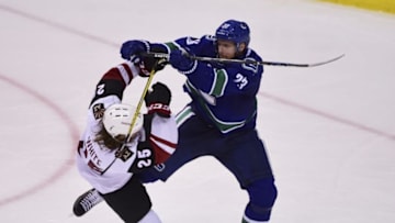 Nov 17, 2016; Vancouver, British Columbia, CAN; Vancouver Canucks defenseman Alexander Edler (23) checks Arizona Coyotes forward Ryan White (25) during the third period at Rogers Arena. Mandatory Credit: Anne-Marie Sorvin-USA TODAY Sports