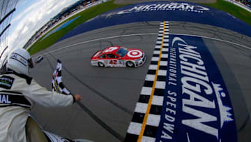 BROOKLYN, MI - AUGUST 13: Kyle Larson, driver of the #42 Target Chevrolet, takes the checkered flag to win the Monster Energy NASCAR Cup Series Pure Michigan 400 at Michigan International Speedway on August 13, 2017 in Brooklyn, Michigan. (Photo by Sean Gardner/Getty Images)