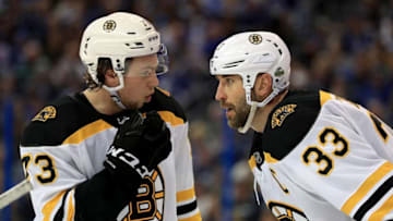 TAMPA, FL - APRIL 30: Charlie McAvoy #73 and Zdeno Chara #33 of the Boston Bruins talk during Game Two of the Eastern Conference Second Round against the Tampa Bay Lightning during the 2018 NHL Stanley Cup Playoffs at Amalie Arena on April 30, 2018 in Tampa, Florida. (Photo by Mike Ehrmann/Getty Images)
