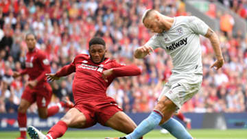 LIVERPOOL, ENGLAND - AUGUST 12: Marko Arnautovic of West Ham United takes a shot and is blocked by Joe Gomez of Liverpool during the Premier League match between Liverpool FC and West Ham United at Anfield on August 12, 2018 in Liverpool, United Kingdom. (Photo by Laurence Griffiths/Getty Images)