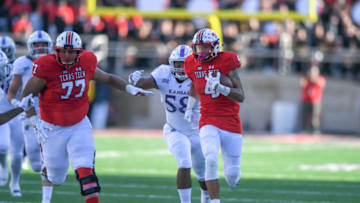 LUBBOCK, TX - OCTOBER 20: Antoine Wesley #4 of the Texas Tech Red Raiders makes the catch and breaks way from the Kansas Jayhawks defense during the second half of the game on October 20, 2018 at Jones AT&T Stadium in Lubbock, Texas. Texas Tech defeated Kansas 48-16. (Photo by John Weast/Getty Images)