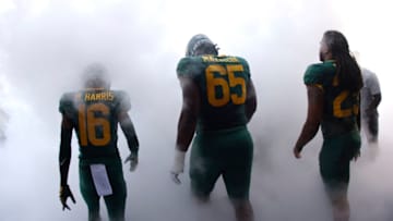 Micah Mazzccua #65 and Richard Reese #29 walk on to the field before playing the playing against the Texas State Bobcats (Photo by Ron Jenkins/Getty Images)