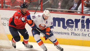 WASHINGTON, DC - FEBRUARY 28: John Taveres #91 of the New York Islanders comes around the goal with the puck with pressure form John Carlson #74 of the Washington Capitals during a NHL hockey game on February 28, 2012 at the Verizon Center in Washington, DC. (Photo by Mitchell Layton/NHLI via Getty Images)