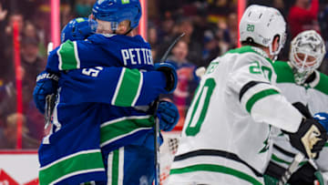 Apr 18, 2022; Vancouver, British Columbia, CAN; Dallas Stars defenseman Ryan Suter (20) looks on as forward Sheldon Dries (51) and forward Elias Pettersson (40) celebrate PetterssonÕs goal in the first period at Rogers Arena. Mandatory Credit: Bob Frid-USA TODAY Sports