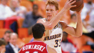 1989: Uwe Blab #33 of the Golden State Warriors looks to pass during an NBA game in the 1989-90 season. NOTE TO USER: User expressly acknowledges and agrees that, by downloading and/or using this Photograph, User is consenting to the terms and conditions of the Getty Images License Agreement. (Photo by: Mike Powell/Getty Images