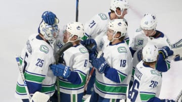 EDMONTON, ALBERTA - AUGUST 06: Jacob Markstrom #25 of the Vancouver Canucks is congratulated by teammate Brock Boeser #6 after Markstrom recorded his first career shutout with the 3-0 win over the Minnesota Wild in Game Three of the Western Conference Qualification Round prior to the 2020 NHL Stanley Cup Playoffs at Rogers Place on August 06, 2020 in Edmonton, Alberta. (Photo by Jeff Vinnick/Getty Images)