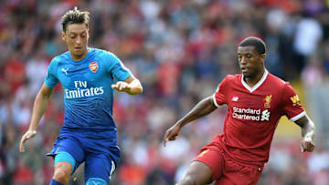 LIVERPOOL, ENGLAND - AUGUST 27: Mesut Ozil of Arsenal and Georginio Wijnaldum of Liverpool battle for possession during the Premier League match between Liverpool and Arsenal at Anfield on August 27, 2017 in Liverpool, England. (Photo by Michael Regan/Getty Images)