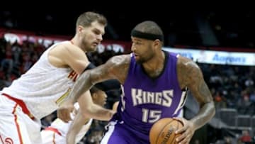 Nov 18, 2015; Atlanta, GA, USA; Sacramento Kings forward DeMarcus Cousins (15) drives against Atlanta Hawks forward Tiago Splitter (11) in the first quarter of their game at Philips Arena. Mandatory Credit: Jason Getz-USA TODAY Sports