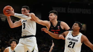 Feb 5, 2022; Boulder, Colorado, USA; Colorado Buffaloes guard Luke O'Brien (0) and forward Evan Battey (21) and Oregon State Beavers center Roman Silva (12) reach for a rebound in the second half at the CU Events Center. Mandatory Credit: Ron Chenoy-USA TODAY Sports