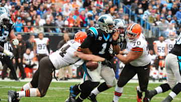 CHARLOTTE, NC - DECEMBER 21: Cam Newton #1 of the Carolina Panthers has the ball stripped by Scott Solomon #54 of the Cleveland Browns on December 21, 2014 at Bank of America Stadium in Charlotte, North Carolina. (Photo by Scott Cunningham/Getty Images)