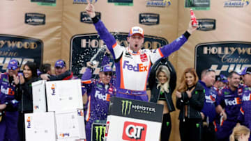 KANSAS CITY, KANSAS - OCTOBER 20: Denny Hamlin, driver of the #11 FedEx Office Toyota, celebrates in Victory Lane after winning the Monster Energy NASCAR Cup Series Hollywood Casino 400 at Kansas Speedway on October 20, 2019 in Kansas City, Kansas. (Photo by Brian Lawdermilk/Getty Images)