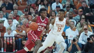 Feb 27, 2016; Austin, TX, USA; Oklahoma Sooners guard Buddy Hield (24) dribbles the ball as Texas Longhorns guard Kerwin Roach (12) defends during the first half at the Frank Erwin Special Events Center. Mandatory Credit: Brendan Maloney-USA TODAY Sports