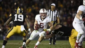 Jan 1, 2016; Pasadena, CA, USA; Stanford Cardinal running back Christian McCaffrey (5) runs against Iowa Hawkeyes linebacker Josey Jewell (43) and defensive back Miles Taylor (19) during the fourth quarter in the 2016 Rose Bowl at Rose Bowl. Mandatory Credit: Richard Mackson-USA TODAY Sports
