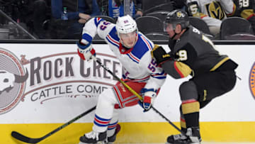 LAS VEGAS, NEVADA - DECEMBER 08: Ryan Lindgren #55 of the New York Rangers skates with the puck under pressure from Reilly Smith #19 of the Vegas Golden Knights in the second period of their game at T-Mobile Arena on December 8, 2019 in Las Vegas, Nevada. The Rangers defeated the Golden Knights 5-0. (Photo by Ethan Miller/Getty Images)