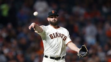 SAN FRANCISCO, CA - AUGUST 11: Pitcher Casey Kelly #68 of the San Francisco Giants fields the ball and throws to first base to get the out of David Freese #23 of the Pittsburgh Pirates in the ninth inning at AT&T Park on August 11, 2018 in San Francisco, California. (Photo by Lachlan Cunningham/Getty Images)