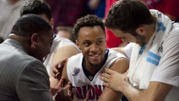 Feb 12, 2016; Tucson, AZ, USA; Arizona Wildcats guard Parker Jackson-Cartwright (0) is congratulated by assistant coach Book Richardson and forward Mark Tollefsen (23) (right) after returning to the bench during the second half against the UCLA Bruins at McKale Center. Arizona won 81-75. Mandatory Credit: Casey Sapio-USA TODAY Sports