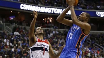 Feb 1, 2014; Washington, DC, USA; Oklahoma City Thunder small forward Kevin Durant (35) shoots the ball over Washington Wizards small forward Trevor Ariza (1) in the third quarter at Verizon Center. The Wizards won 96-81. Mandatory Credit: Geoff Burke-USA TODAY Sports