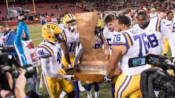 Nov 12, 2016; Fayetteville, AR, USA; LSU Tigers guard Josh Boutte (76) and LSU Tigers linebacker Donnie Alexander (48) carry The Boot trophy after defeating the Arkansas Razorbacks 38-10 at Donald W. Reynolds Razorback Stadium. LSU won 38-10. Mandatory Credit: Brett Rojo-USA TODAY Sports