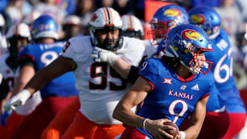 LAWRENCE, KS - NOVEMBER 05: Quarterback Jason Bean #9 of the Kansas Jayhawks runs for a 73-yard touchdown against the Oklahoma State Cowboys in the first half at David Booth Kansas Memorial Stadium on November 5, 2022 in Lawrence, Kansas. (Photo by Ed Zurga/Getty Images)